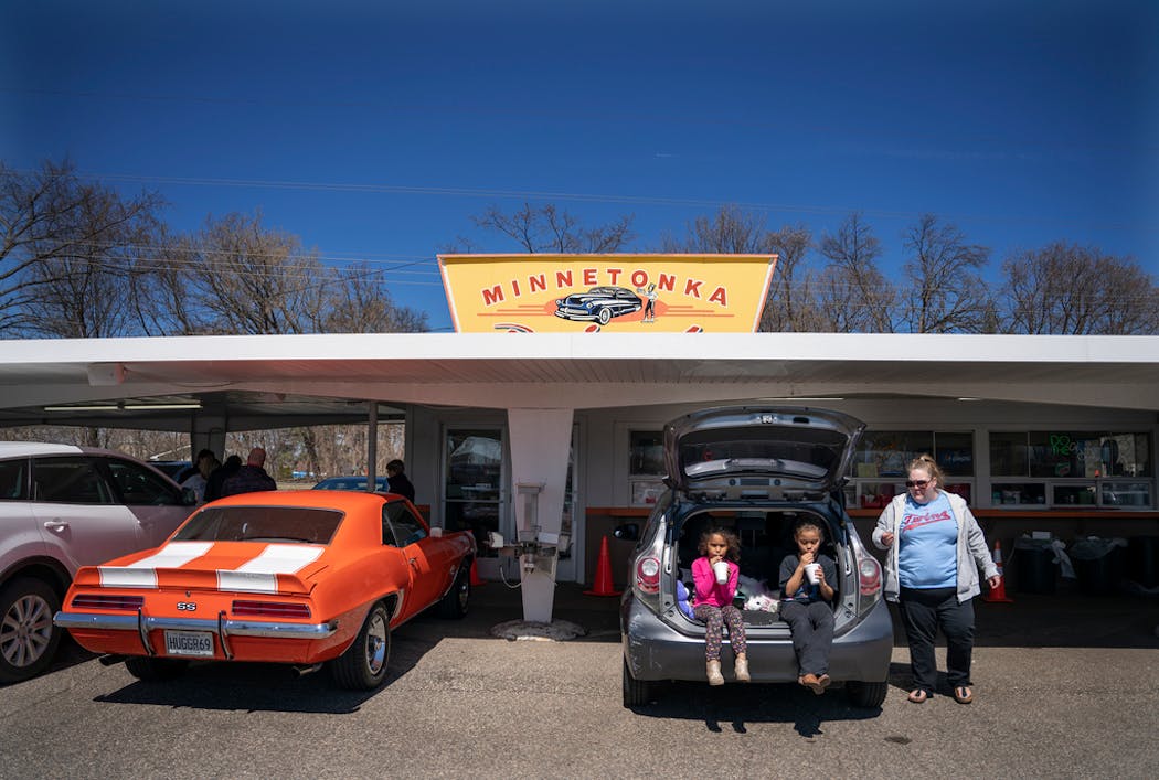 Erica Morningstar with her two daughters, Bryn and Brielle Redding, enjoyed a root beer at Minnetonka Drive In in April.
