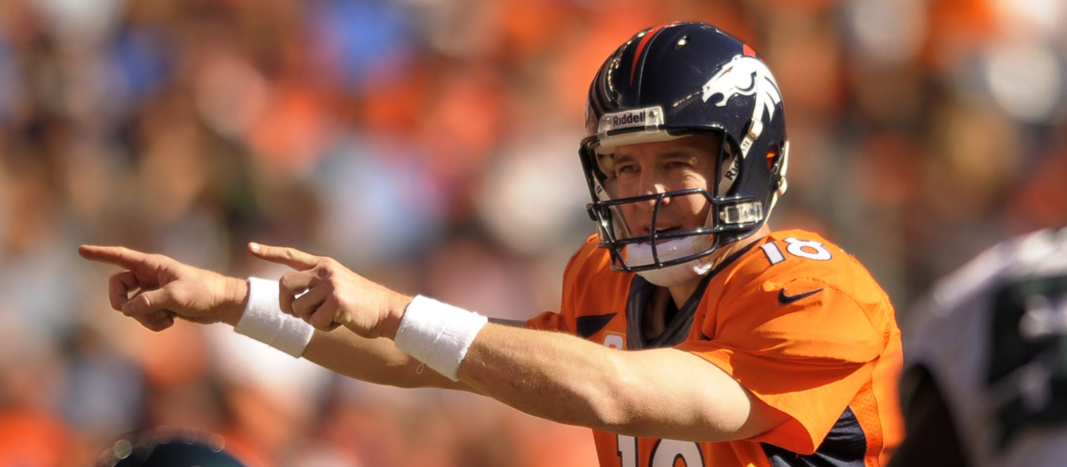 Denver Broncos quarterback Peyton Manning (18) calls an audible at the line of scrimmage against the Philadelphia Eagles in the second quarter of an NFL football game, Sunday, Sept. 29, 2013, in Denver. (AP Photo/Jack Dempsey)