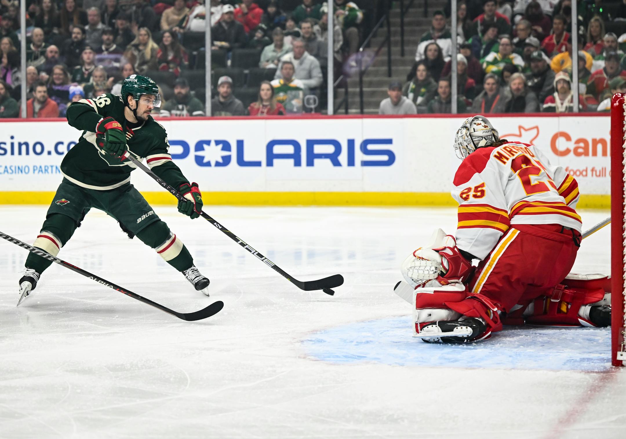 Minnesota Wild right wing Mats Zuccarello (36) attemps a shot against Calgary Flames goaltender Jacob Markstrom (25) during the first period of an NHL hockey game Tuesday, March 7, 2023 at the Xcel Energy Center in St. Paul, Minn.