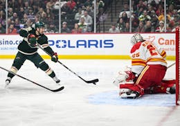 Minnesota Wild right wing Mats Zuccarello (36) attemps a shot against Calgary Flames goaltender Jacob Markstrom (25) during the first period of an NHL