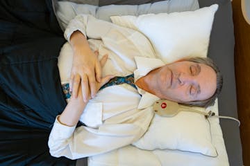 Bill Alkofer lays back to nap in his bed in a St. Paul nursing home in April. Living with ALS, he is almost completely paralyzed, but can turn his hea