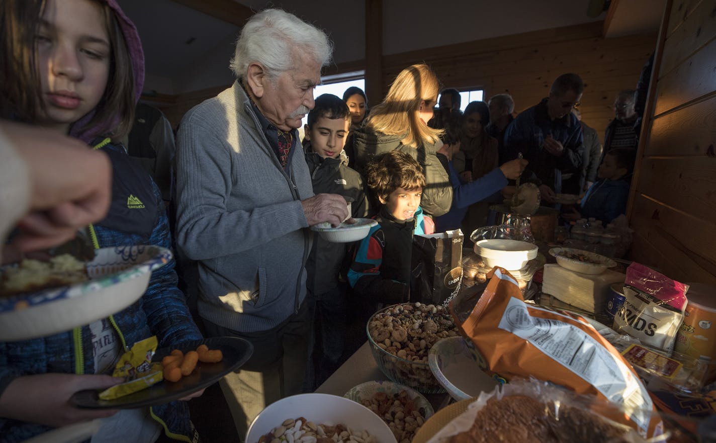 Abbas Azod gathered food at the event, which drew more than 100 people when only a few close friends and neighbors had been initially invited. .