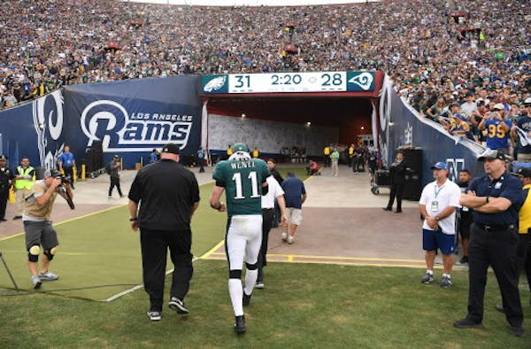 Carson Wentz walked off the field after suffering a season-ending knee injury against the Rams.
