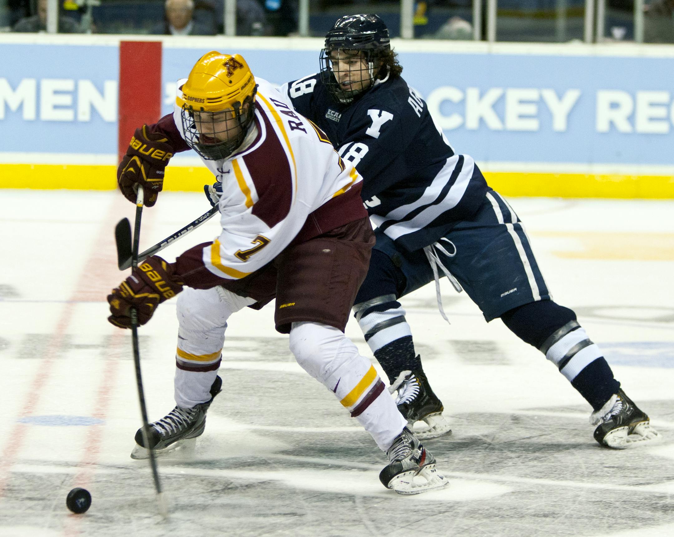 Minnesota's Kyle Rau, left, skates against Yale's Kenny Agostino in the first period of the NCAA Division I Hockey college regional tournament game in Grand Rapids, Mich., Friday, March 29, 2013. (AP Photo/The Grand Rapids Press, Cory Morse) ALL LOCAL TV OUT; LOCAL TV INTERNET OUT. ORG XMIT: MIGRA301