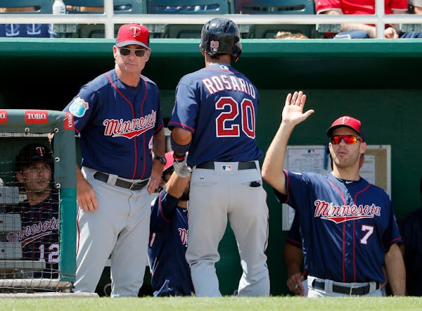 Twins manager Paul Molitor, left, and Joe Mauer (7) congratulated Eddie Rosario (20) on his solo home run off the Red Sox's Clay Buchholz in the fourt