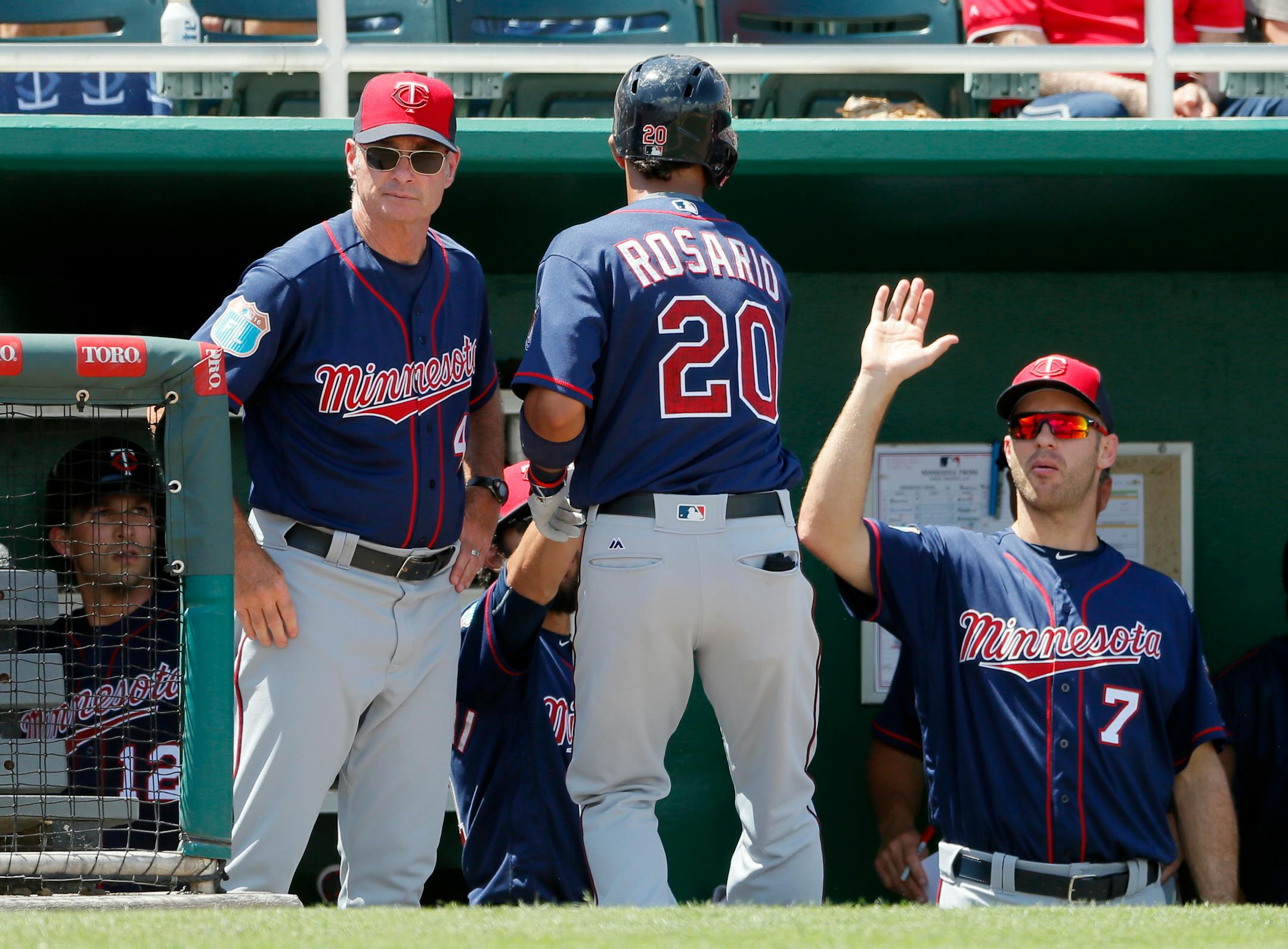 Twins manager Paul Molitor, left, and Joe Mauer (7) congratulated Eddie Rosario (20) on his solo home run off the Red Sox's Clay Buchholz in the fourth inning Thursday.