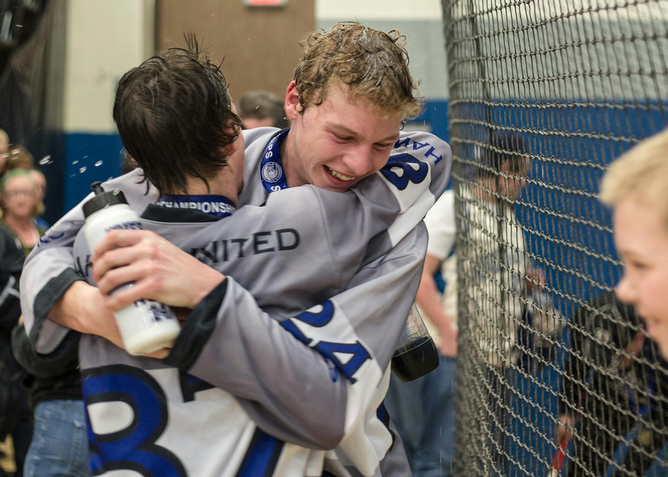 Grayson Nicolay, 87, has the most scores in the division, hugs Nick Kuefler, 24, after the Hawks win against the Mustang's at Bloomington Jefferson High School Saturday afternoon. [ Elizabeth Brumley special to the Star Tribune * Dakota United Hawks -- PI South Division played Anoka-Hennepin Mustangs-- PI North Division at Bloomington Jefferson High School Saturday afternoon.