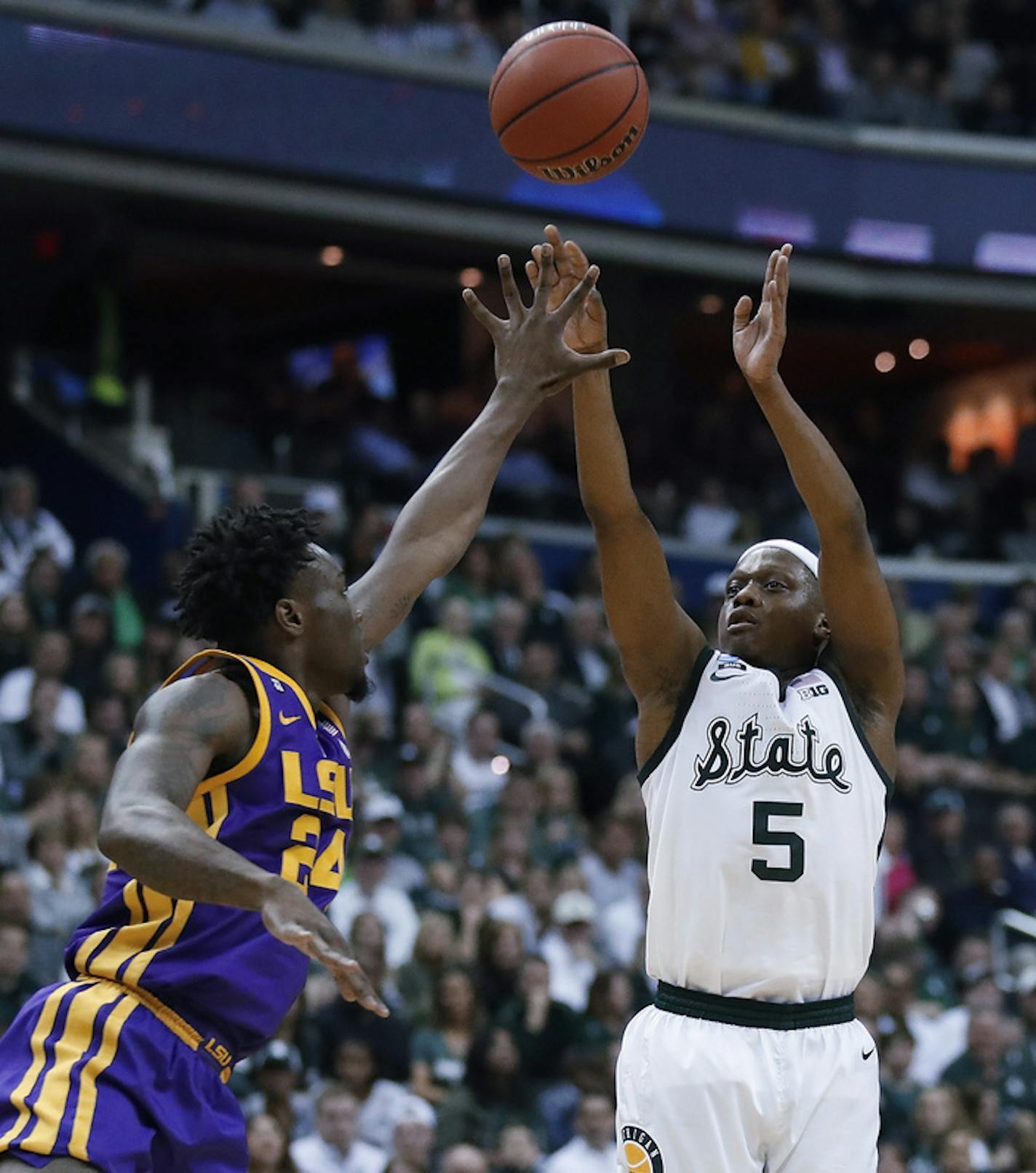 Michigan State guard Cassius Winston shoots over LSU forward Emmitt Williams (24) during the first half of an East Regional semifinal in the NCAA men's college basketball tournament Friday, March 29, 2019, in Washington.(AP Photo/Alex Brandon)