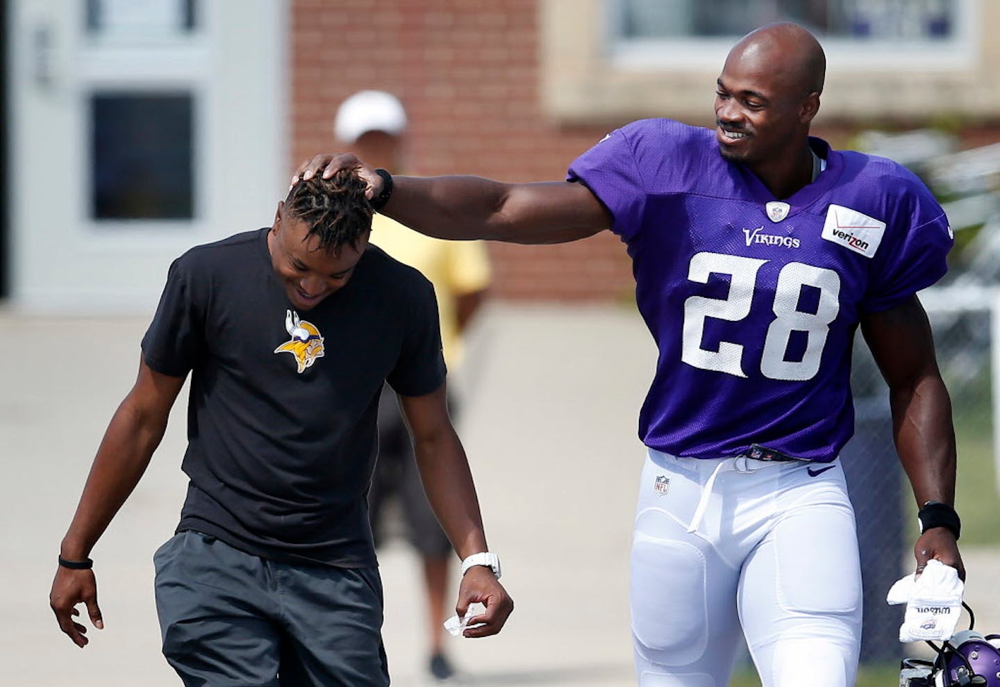 Minnesota Vikings running back Adrian Peterson (28) joked with equipment assistant E.J. Johnson before Tuesday�s afternoon practice. ] CARLOS GONZALEZ cgonzalez@startribune.com - August 11, 2015, Mankato, MN, NFL, Minnesota Vikings Training Camp, Minnesota State University, Mankato,