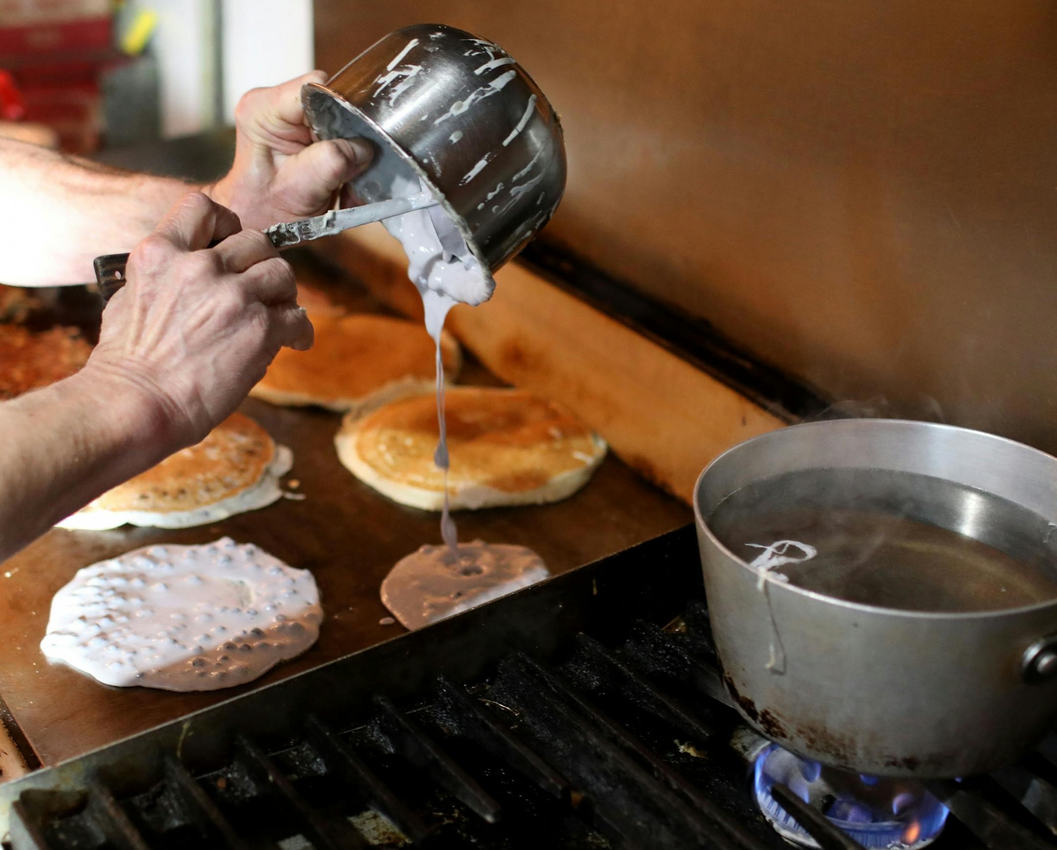 Doug Grina, a staple character at Al's Breakfast for 42 years, works behind the counter on Wednesday, Dec. 18, 2019.