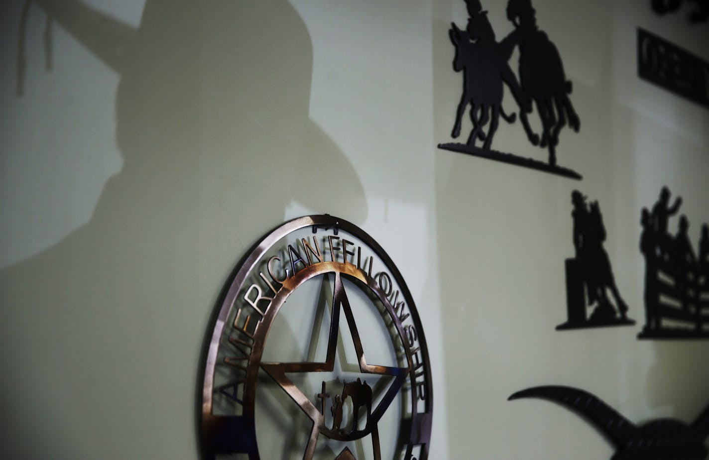 At the Open Range Cowboy Church in Isanti, one of the churchgoers cast a shadow on ironwork for sale.] tsong-taataarii@startribune.com