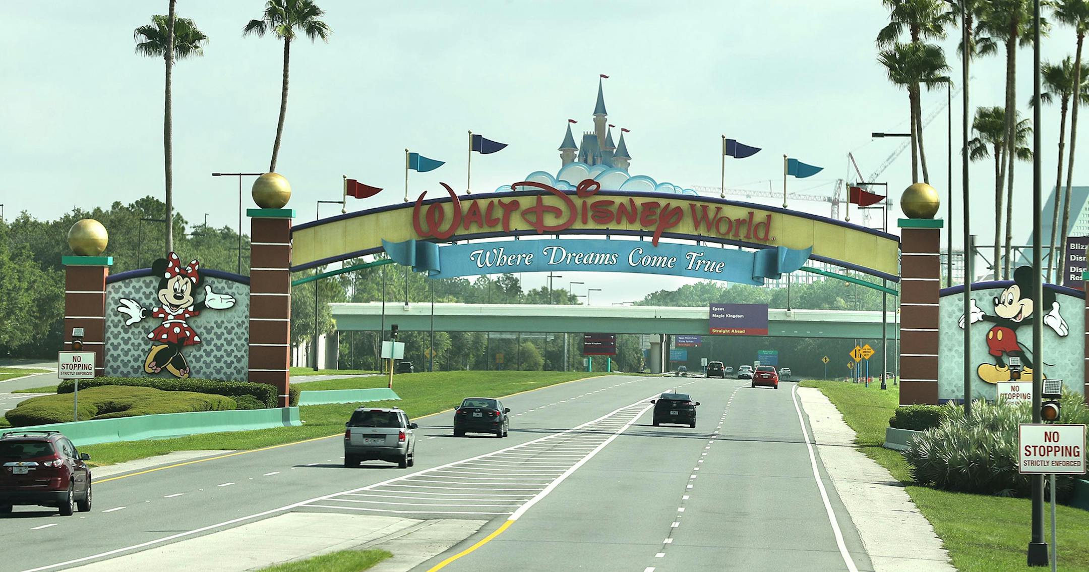 Guests drive toward the entrance of Walt Disney World's Magic Kingdom in Orlando, Florida, on Saturday, July 11, 2020. The theme park reopened at limited capacity during the Coronavirus pandemic. (Stephen M. Dowell/Orlando Sentinel/TNS)
