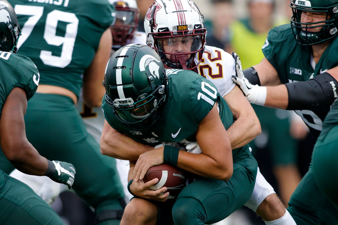 Michigan State quarterback Payton Thorne is sacked by the Gophers' Ryan Stapp during the first quarter Saturday.