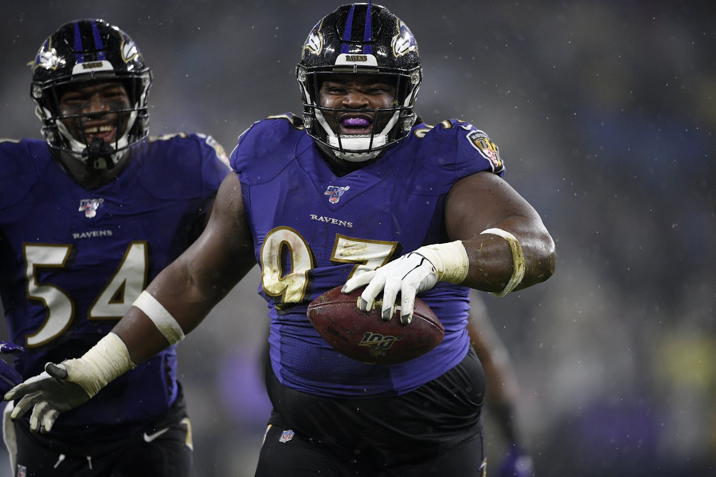 FILE - In this Sunday, Dec. 29, 2019 file photo, Baltimore Ravens defensive tackle Michael Pierce (97) celebrates his fumble recovery with linebacker Tyus Bowser (54) during the first half of an NFL football game against the Pittsburgh Steelers in Baltimore. Michael Pierce has agreed to terms with the Minnesota Vikings, Wednesday, March 18, 2020. (AP Photo/Nick Wass, File)