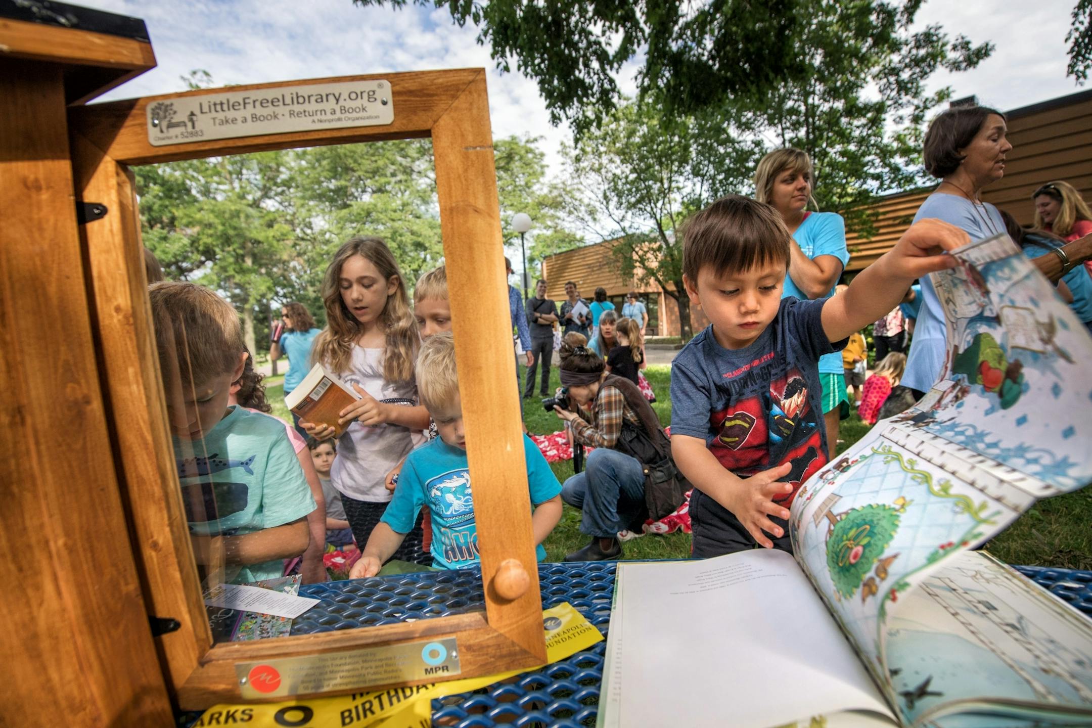 Kids looked through the Little Free Library books after the ceremony.