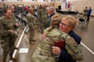 Command Chief Master Sgt. Lisa Erikson gets a hug from Senior Master Sgt. Holly Kneisl, the military personnel superintendent, following a ceremony to