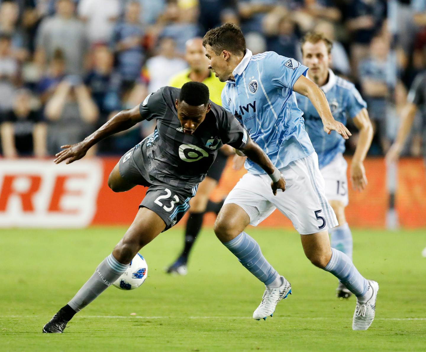 Minnesota United forward Mason Toye (23) loses control of the ball as Sporting Kansas City defender Matt Besler (5) defends