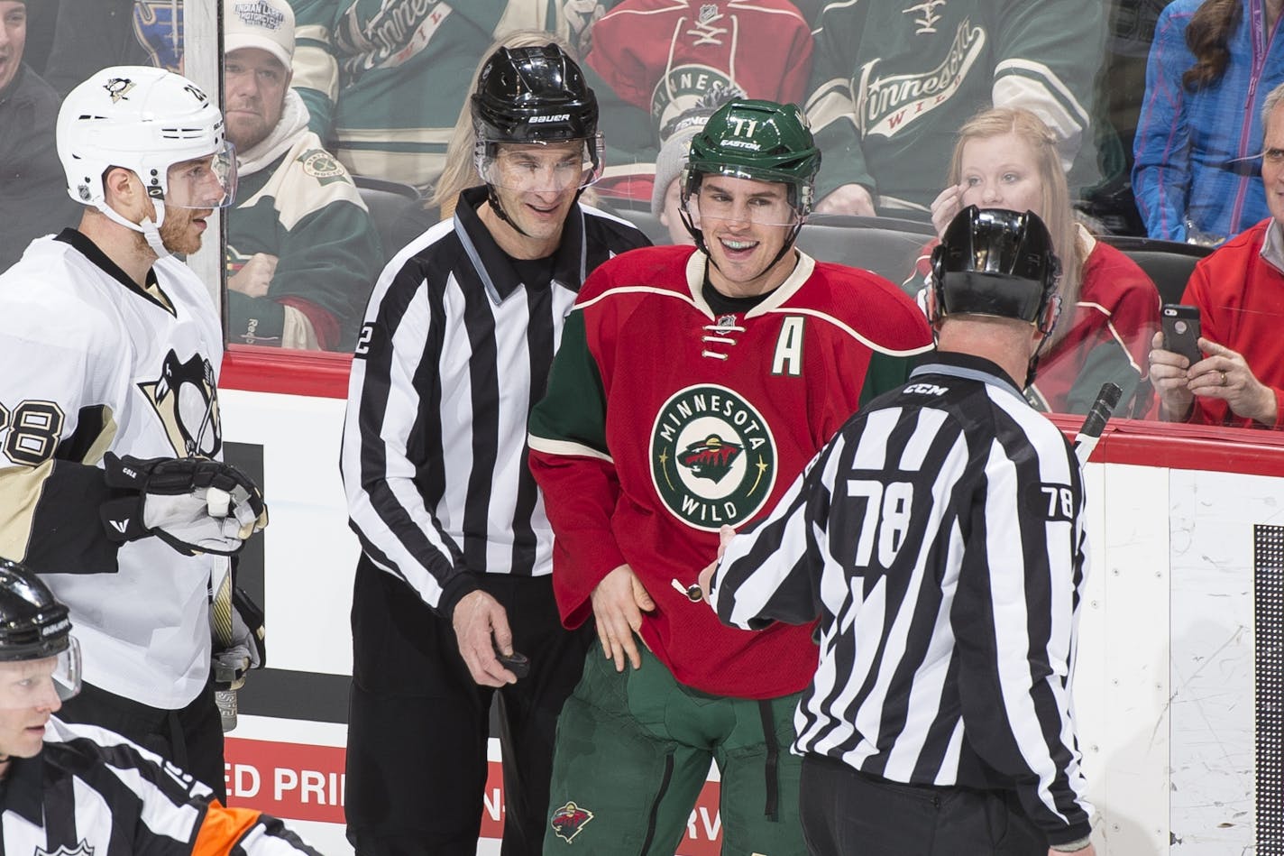 Minnesota Wild left wing Zach Parise (11) laughed with officials after the puck disappeared into his jersey, temporarily haulting a Wild power play late in the first period.