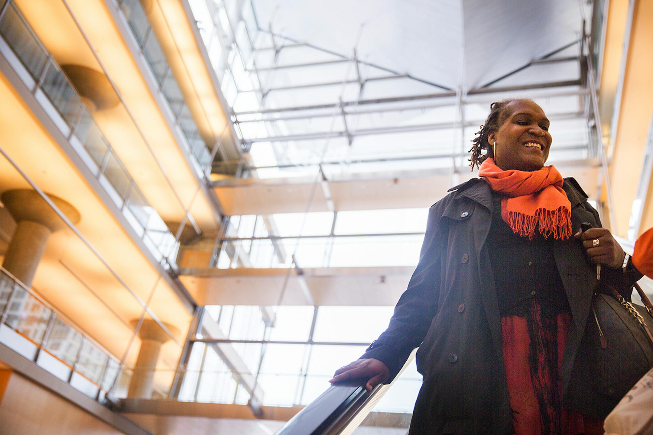 Local writer Andrea Jenkins takes the escalator down after participcating in Queer Voices, an event she co-curated to bring together LGBT poets and writers as part of the Association of Writers & Writing Conference, at the Minneapolis Central Library in downtown Minneapolis on Thursday, April 9, 2015. ] LEILA NAVIDI leila.navidi@startribune.com /