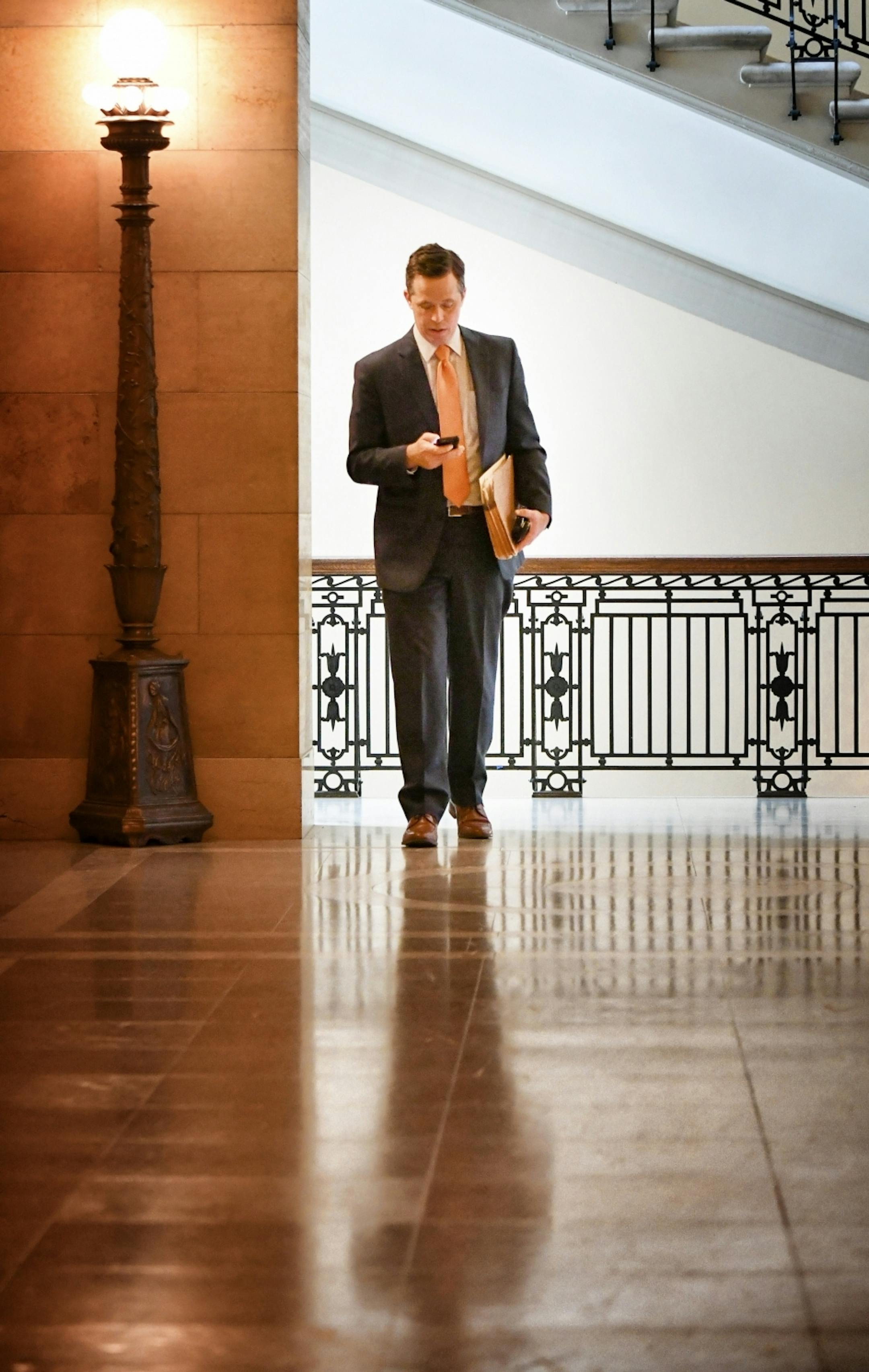 Ben Golnik, Executive Director, Majority Caucus, checked messages on the way to a GOP caucus meeting.