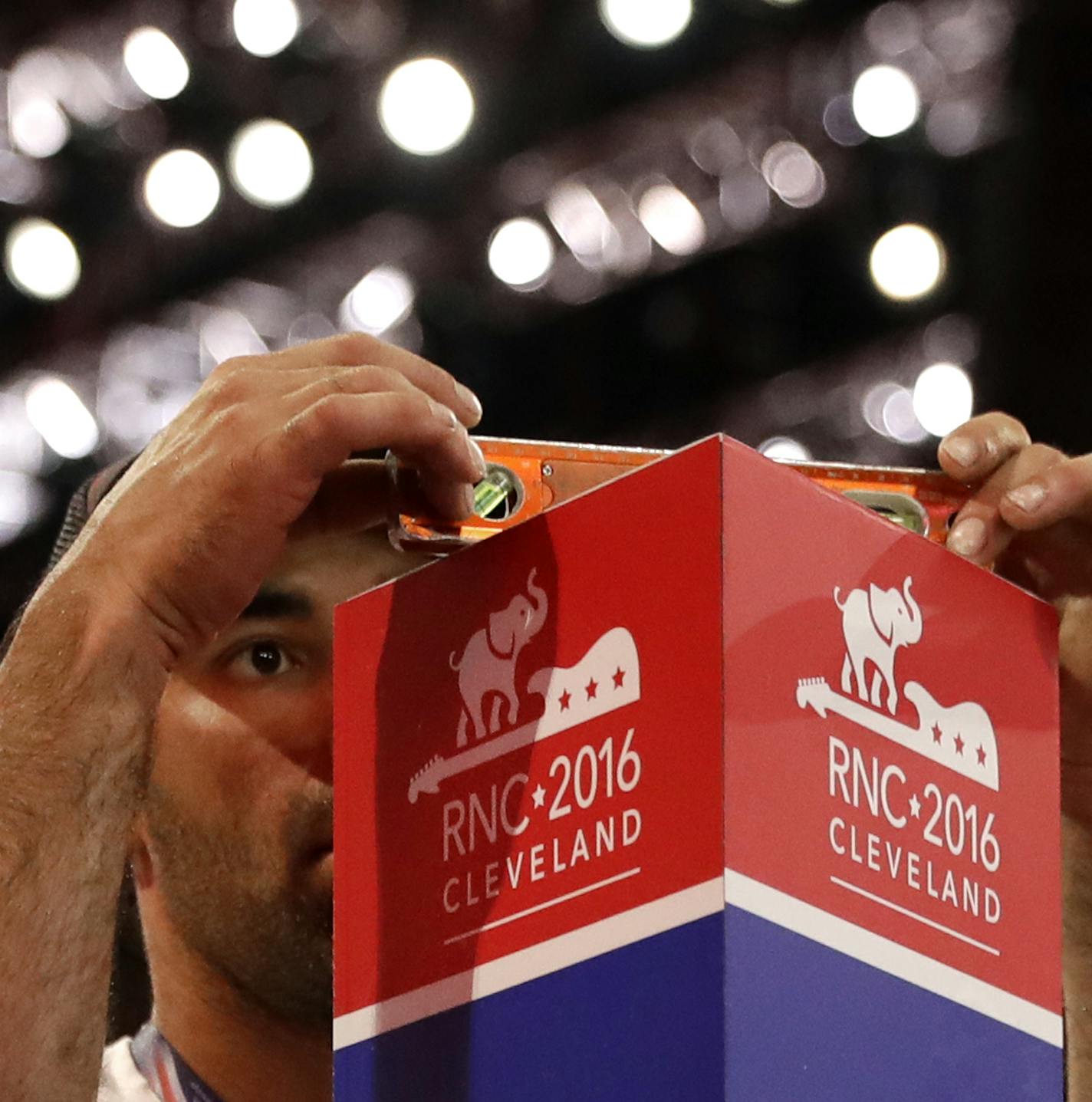 Daniel Shepherd levels a pole marking the section for delegates from the District of Columbia as preparations take place for the Republican National Convention inside Quicken Loans Arena in Cleveland, Ohio, Saturday, July 16, 2016. (AP Photo/Patrick Semansky)