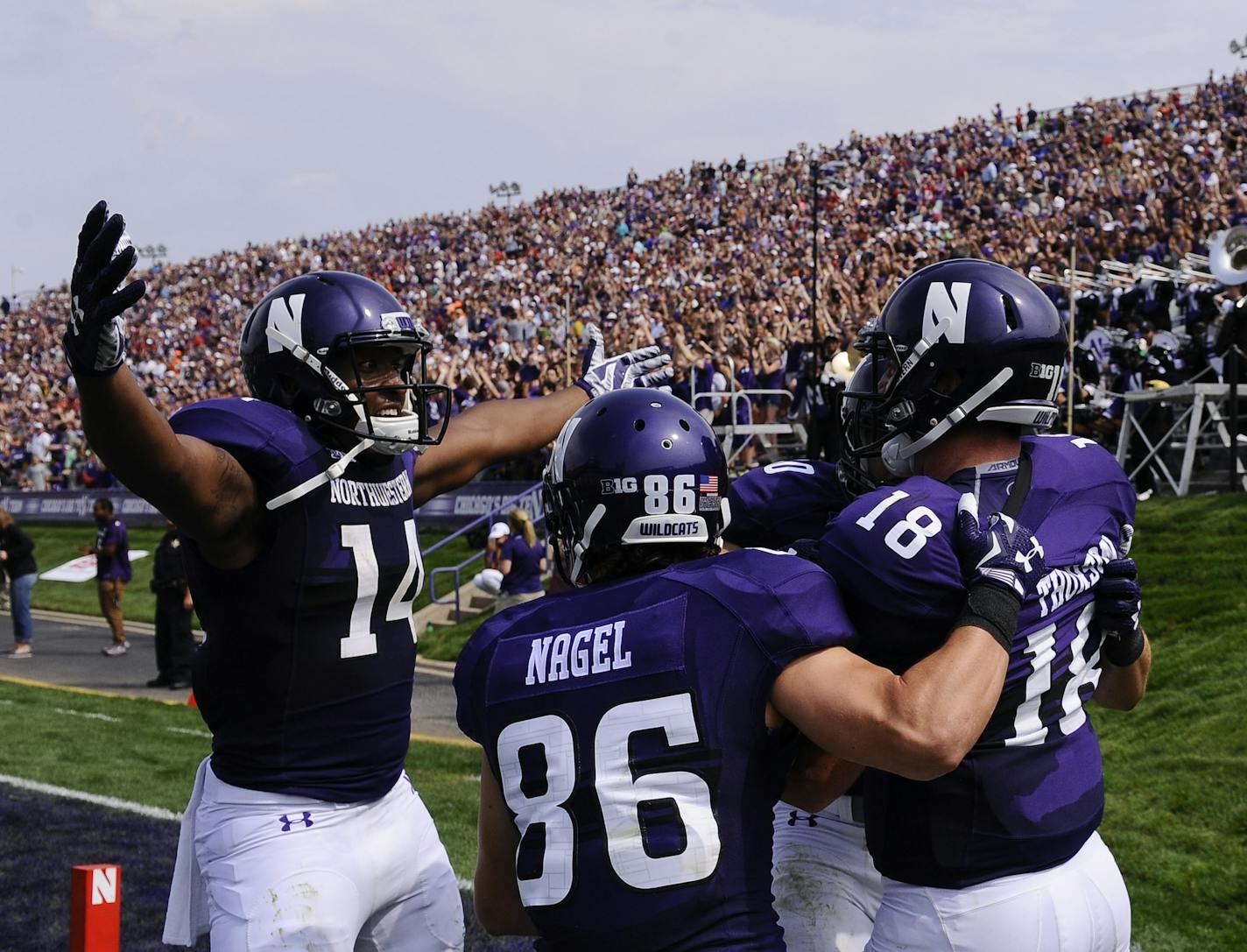 Northwestern quarterback Clayton Thorson (18) celebrates with Northwestern wide receiver Flynn Nagel (86), Northwestern wide receiver Austin Carr (80) and Northwestern wide receiver Christian Jones (14) after he ran for a touchdown against Stanford earlier this season.