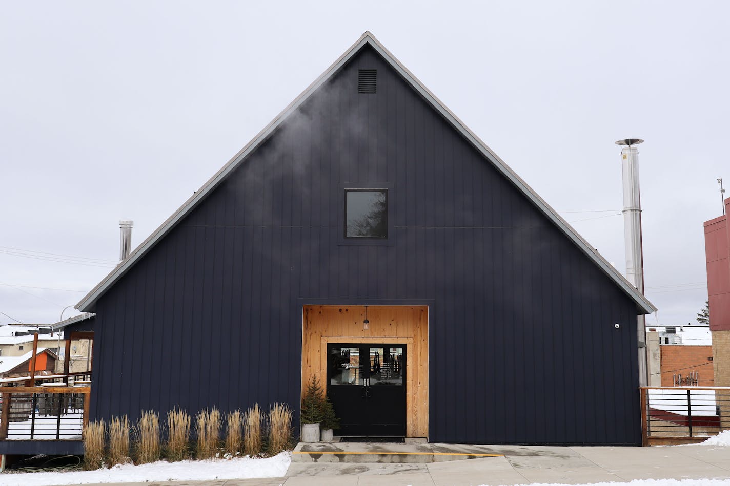 The dark a-fram exterior of Portage Brewing in Walker, MN during winter.