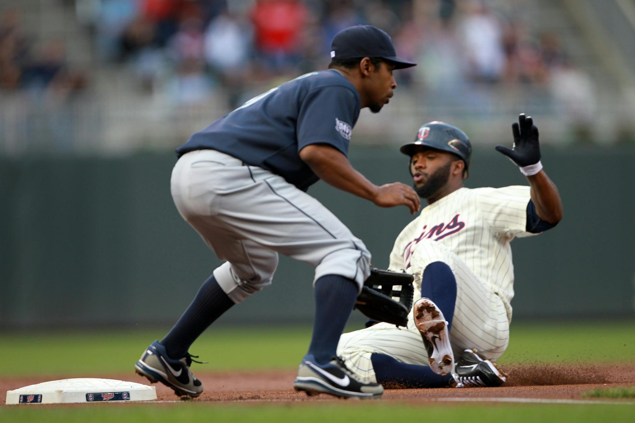 Twins lead off hitter Denard Span tripled in the first inning Tuesday night. Mariners third baseman Chone Figgins did not make the tag.