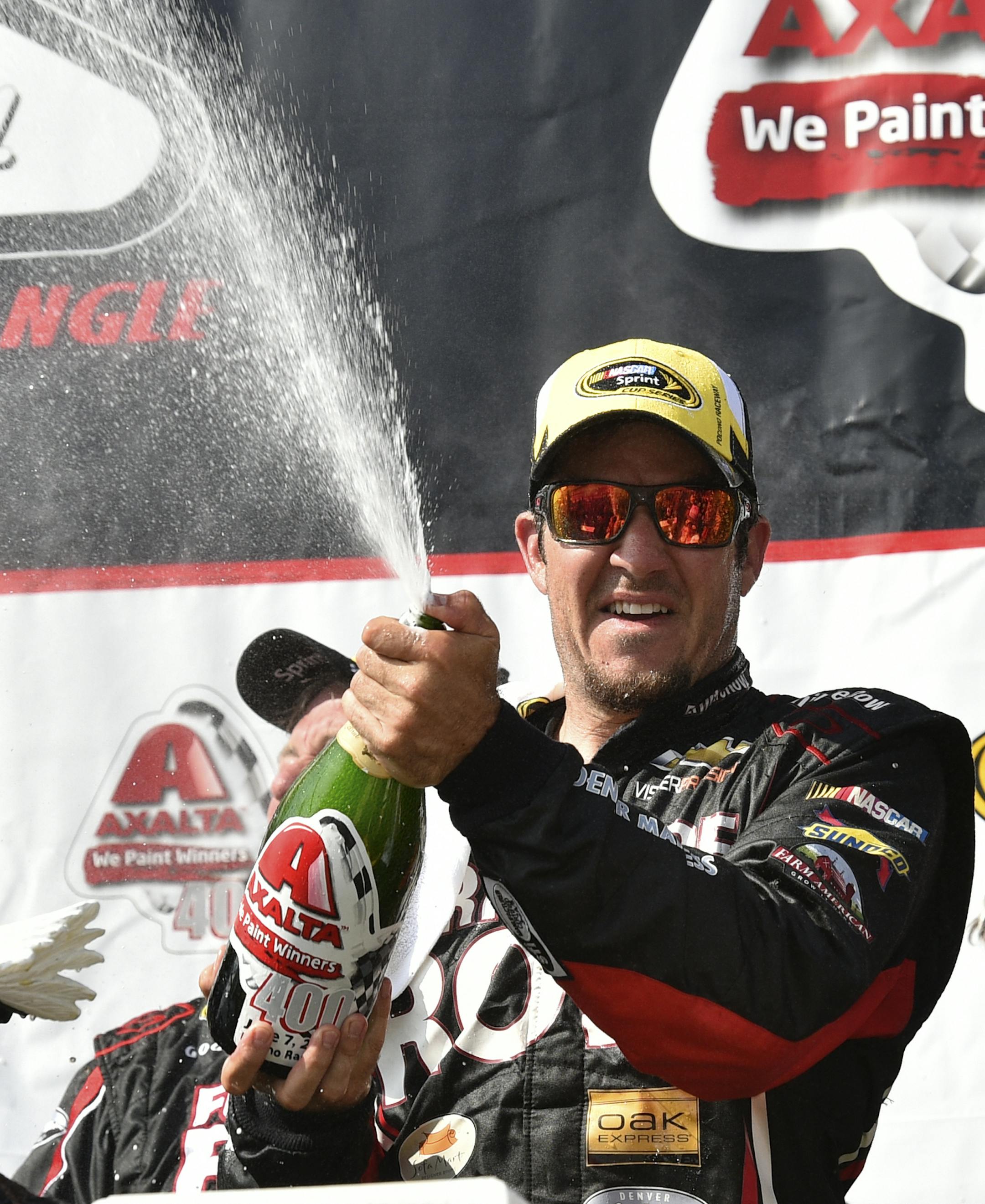 Martin Truex Jr. celebrates in Victory Lane at Pocono Raceway after winning a NASCAR Sprint Cup Series auto race at Pocono Raceway in Long Pond, Pa., Sunday, June 7, 2015. (AP Photo/Derik Hamilton)