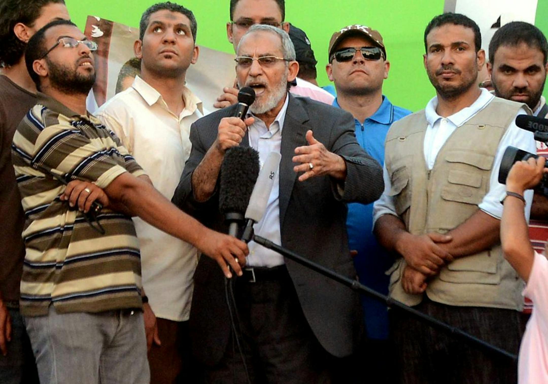 July 5, 2013: Muslim Brotherhood leader Mohammed Badie speaks onstage as military helicopters fly overhead before tens of thousands of supporters in Cairo.