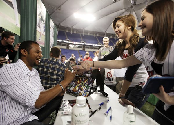 Aaron Hicks signed autographs for fans at TwinsFest in 2012.