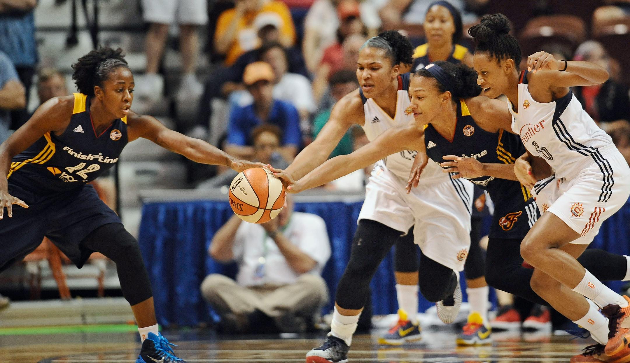 Indiana Fever's Lynetta Kizer, left, and Marissa Coleman, right center, pursue a loose ball against Connecticut Sun's Alyssa Thomas, center, and Jasmine Thomas, right, during the first half of a WNBA basketball game, Tuesday, July 28, 2015, in Uncasville, Conn.