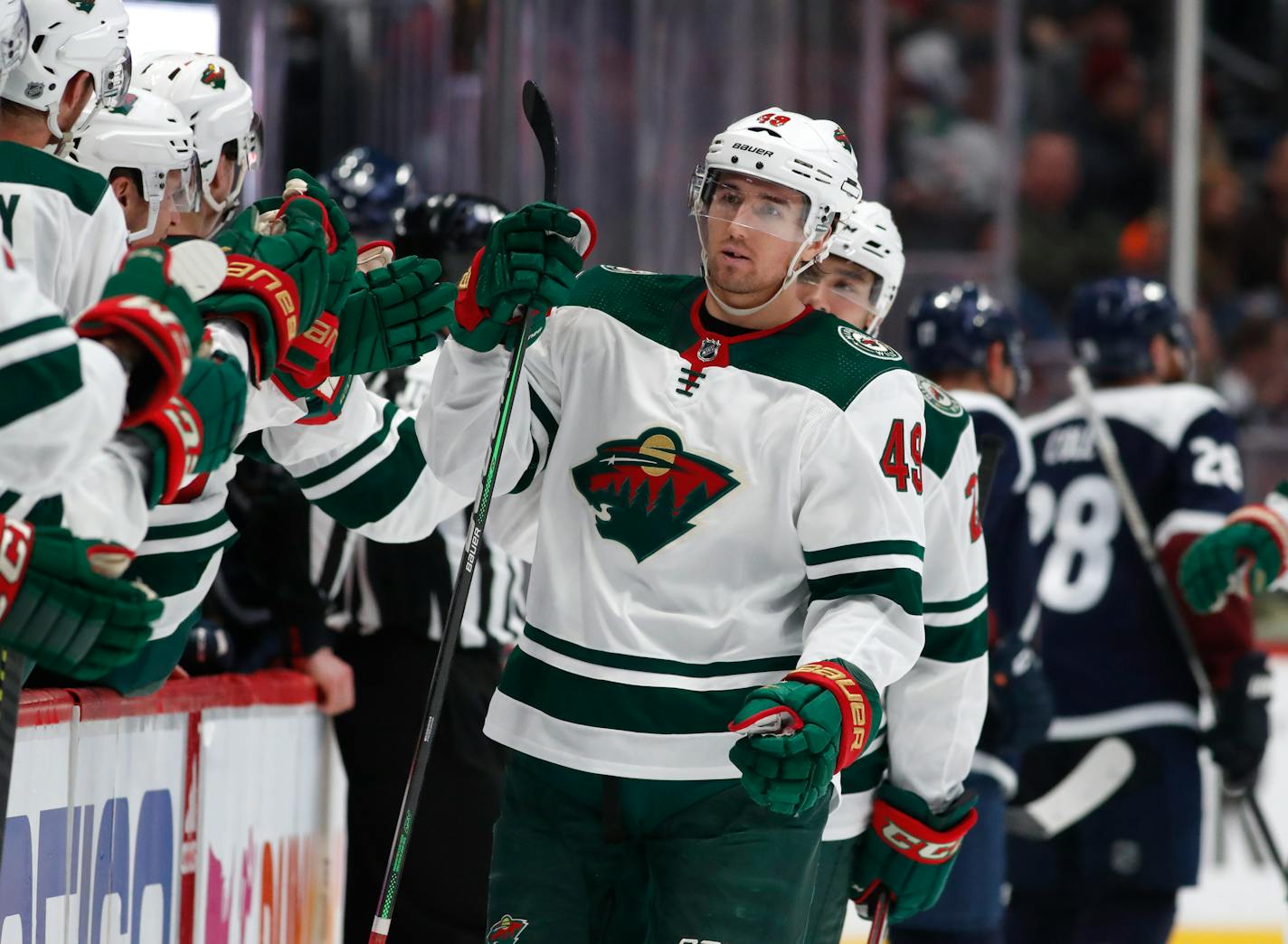 Minnesota Wild center Victor Rask, right, is congratulated as he passes the team box after scoring the go-ahead goal against the Colorado Avalanche in the third period of an NHL hockey game Friday, Dec. 27, 2019, in Denver. (AP Photo/David Zalubowski)