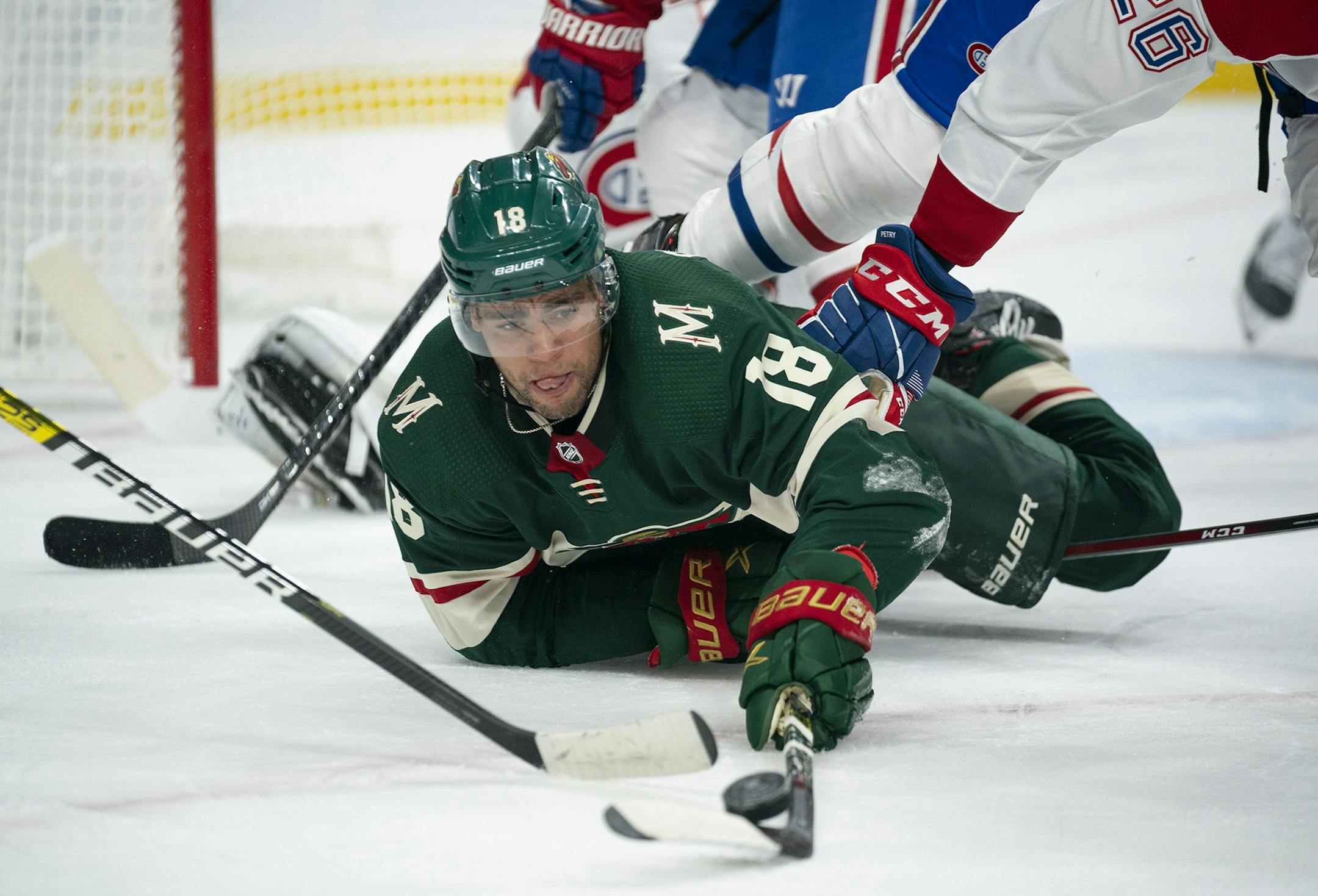 Minnesota Wild left wing Jordan Greenway (18) keeps control of the puck after dropping to the ice in the first period while defended by Montreal Canadiens defenseman Jeff Petry (26) on Sunday, Oct. 20, 2019 at Xcel Energy Center in St. Paul, Minn. (Jeff Wheeler/Minneapolis Star Tribune/TNS) ORG XMIT: 1466583