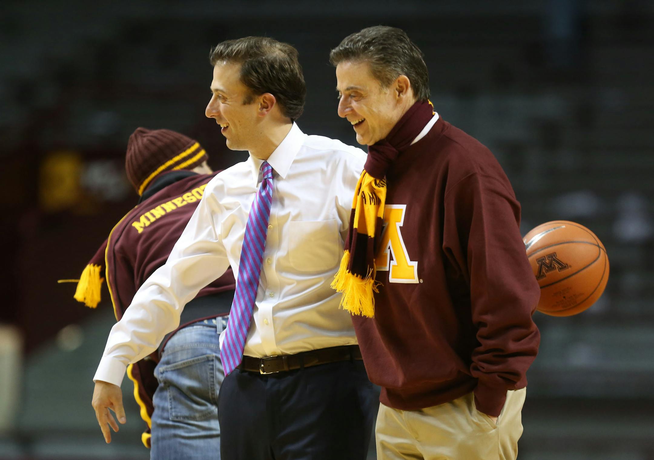 Richard Pitino, left, won't see his father, Rick, in the stands when the Gophers open the NCAA basketball tournament against Louisville, where his dad once coached.