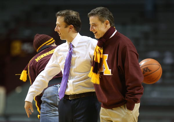 Richard Pitino, left, won't see his father, Rick, in the stands when the Gophers open the NCAA basketball tournament against Louisville, where his dad