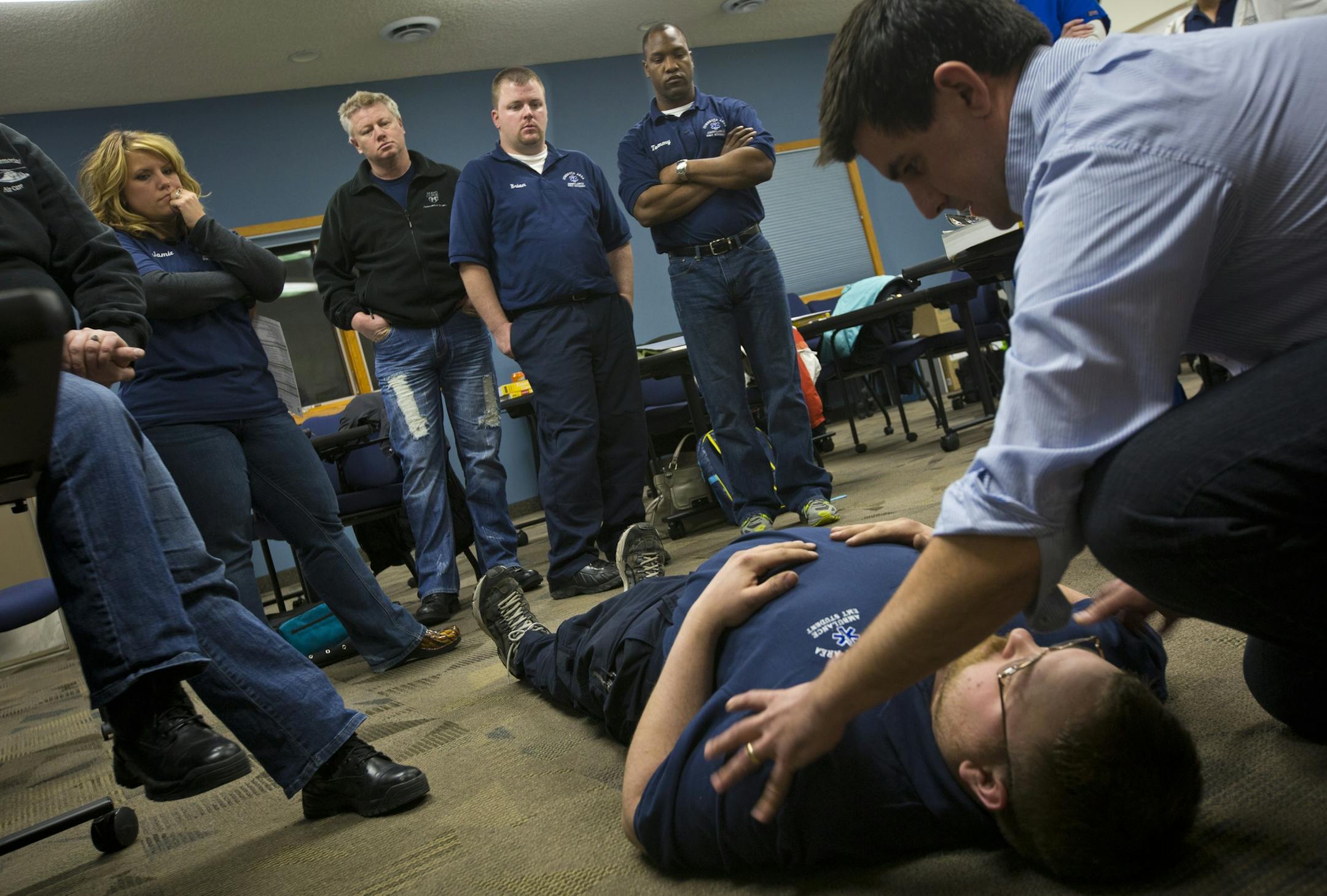 Classmates looked on as Kevin Daily did a training exercise on on D.J. Schiell during a EMS training class on Thursday, February 13, 2014 in Zumbrota, Minn. Some outstate volunteer EMS services are struggling to get and keep people while the population is aging and will need them more than ever.] (RENEE JONES SCHNEIDER reneejones@startribune.com) ORG XMIT: MIN1402141918252444