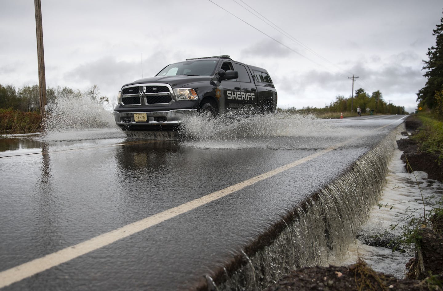 A Sheriff's vehicle passed through high water in a section of County Highway K in South Range, WI. The road was washed out and eventually closed off on Monday morning due to heavy rain that started Sunday night. ]
ALEX KORMANN &#x2022; alex.kormann@startribune.com Northwestern Wisconsin saw some severe flash flooding Monday morning that washed out and damaged several roads, forcing authorities tossup down parts of County Highway K.