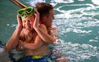 (Left) John Schroeder played with his son, Aiden, in the indoor pool at Beacon Pointe Resort in Duluth on Saturday. The Schroeder family was visiting 