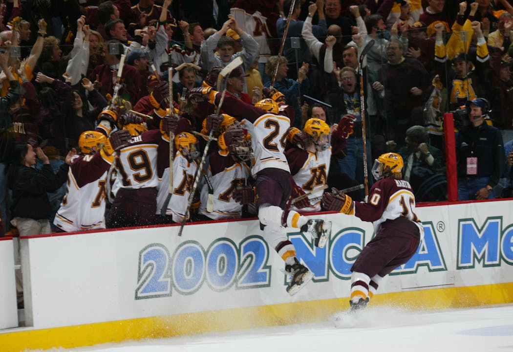 Matt Kolska leaps into the Gophers bench after tying the game in the final minute.