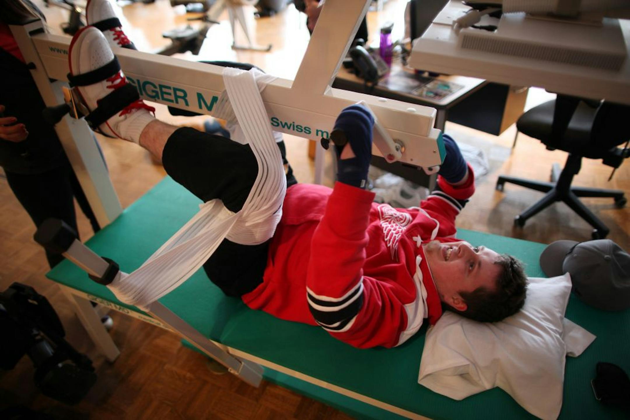 Brendan Loney, who was paralyzed in a diving accident, works out at the Courage Center to regain mobility and retain muscle tone.