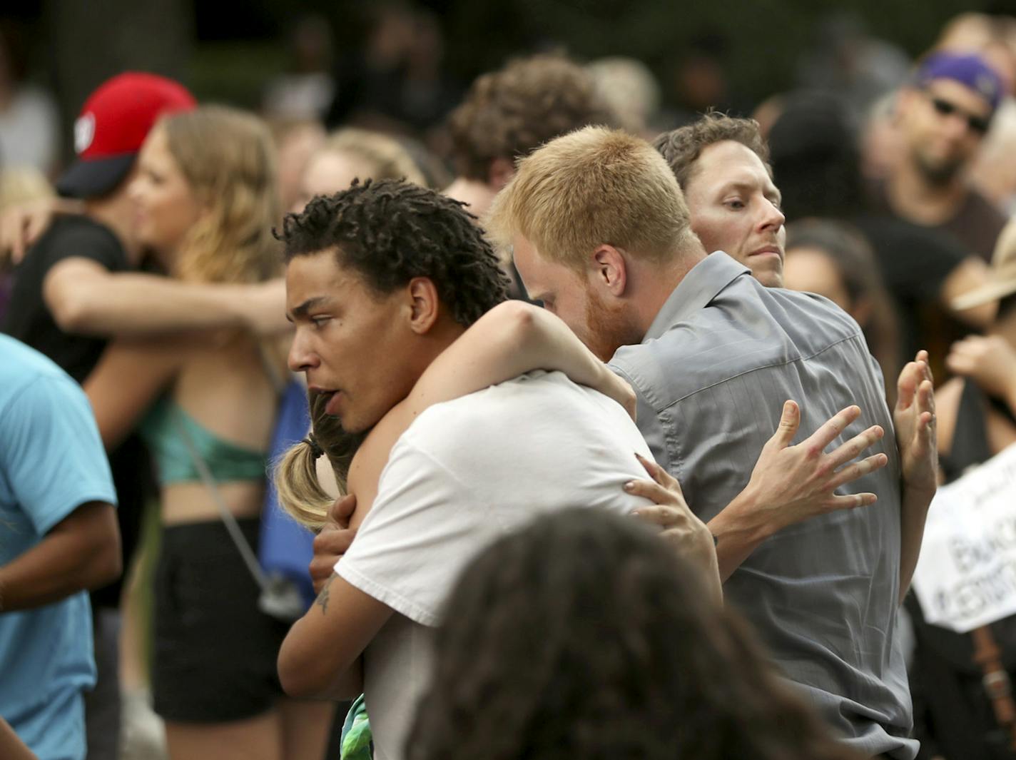 One of the speakers in front of the Governor's residence Sunday night encouraged everyone sitting on the street to stand up and hug a stranger, which everyone readily did. ] JEFF WHEELER &#xd4; jeff.wheeler@startribune.com A few hundred demonstrators continued the presence at the Governor's residence on Summit Ave., listening to a broad range of speakers in St. Paul Sunday night, July 10, 2016. ORG XMIT: MIN1607102025180079