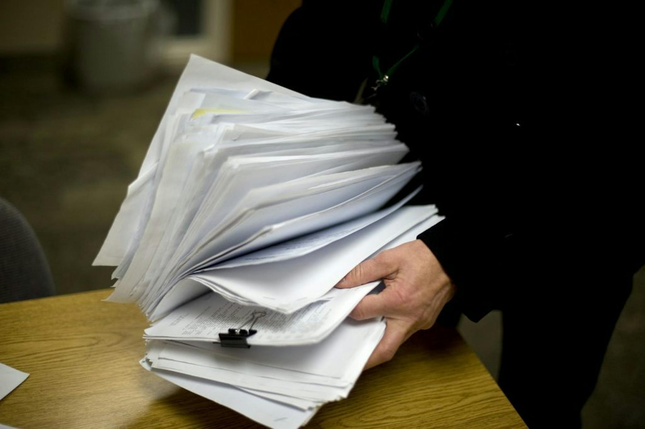 Linda Devine of Faribault with the paperwork related to her loan modification.