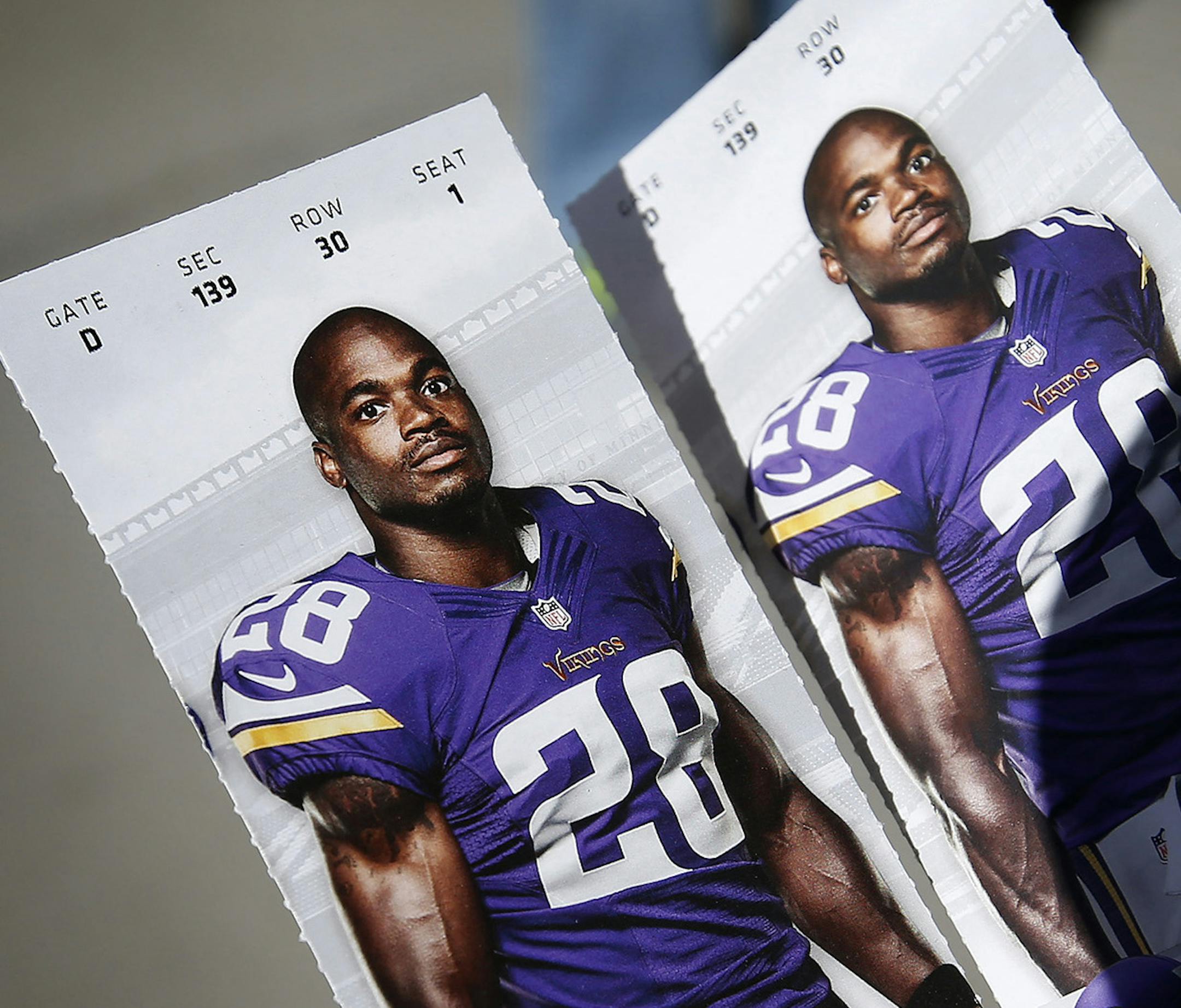 A fan held his tickets, for Sunday's game TCF Bank Stadium between the Minnesota Vikings vs. New England Patriots, which had a photo of Vikings running back Adrian Peterson. ] CARLOS GONZALEZ cgonzalez@startribune.com - September 14 , 2014 , Minneapolis, Minn., NFL, TCF Bank Stadium, Minnesota Vikings vs. New England Patriots ORG XMIT: MIN1409141148061156