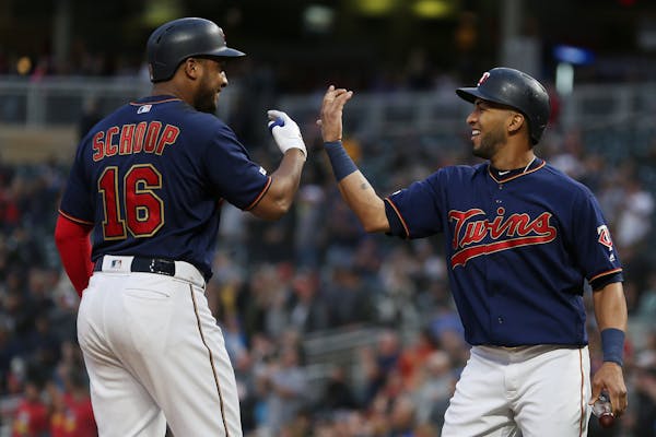 Jonathan Schoop, left, greets Eddie Rosario after they scored on Schoop's home run against the Mariners during the fourth inning