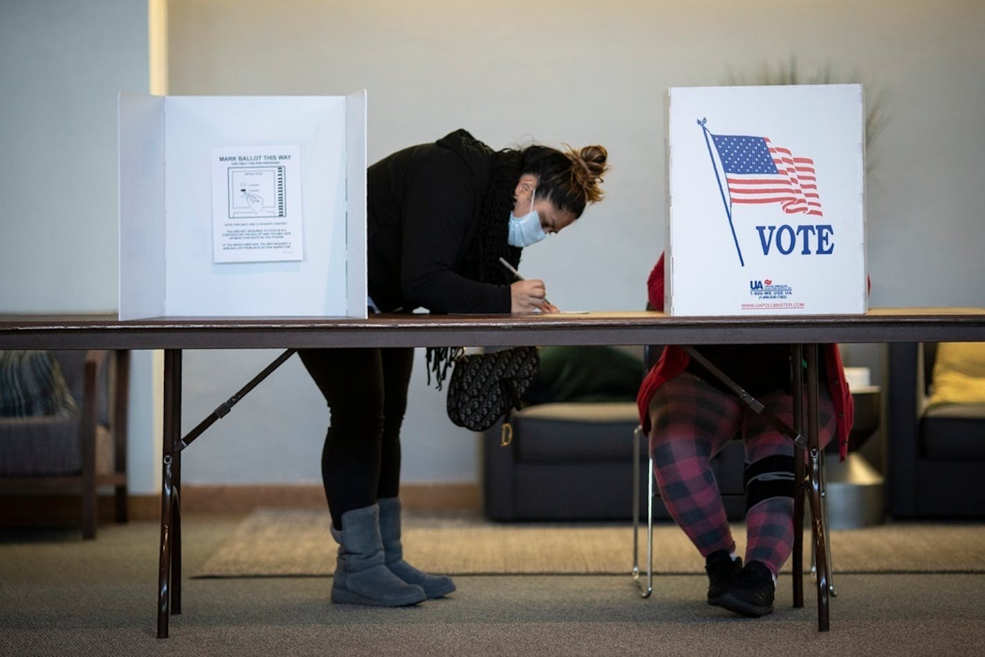 Voters mark their ballots at Journey Church polling center on Election Day on Tuesday, Nov. 3, 2020, in Kenosha, Wis. (AP Photo/Wong Maye-E)