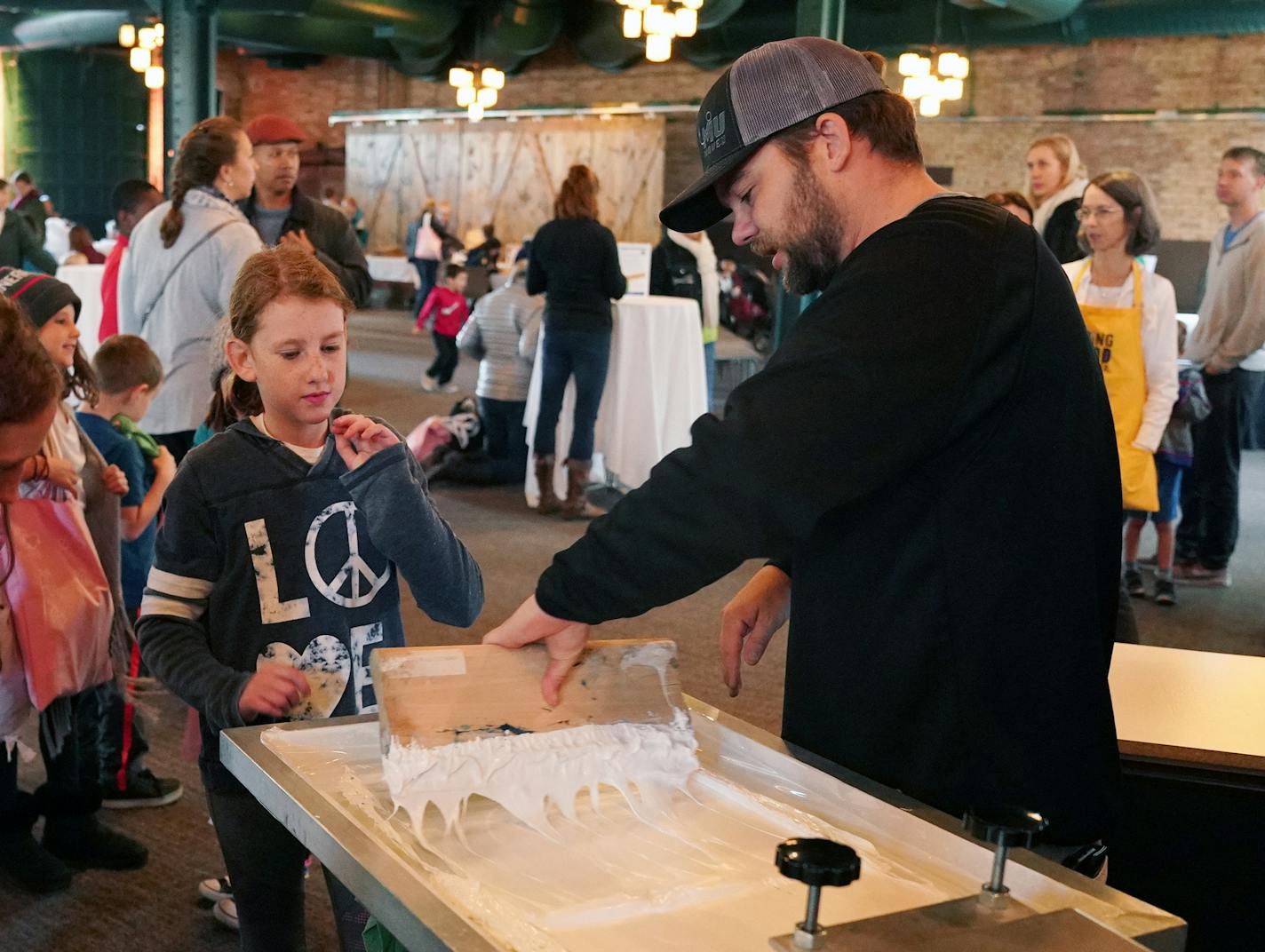 Josh Ostrowski with the Teehive helped attendees make Doing Good Together shirts. ] ANTHONY SOUFFLE &#xef; anthony.souffle@startribune.com The nonprofit Doing Good Together sponsored the first-ever Festival of Giving, where parents and children volunteered shoulder to shoulder and learned about other ways to give back Sunday, Sept. 30, 2018 at the Nicollet Island Pavilion in Minneapolis.