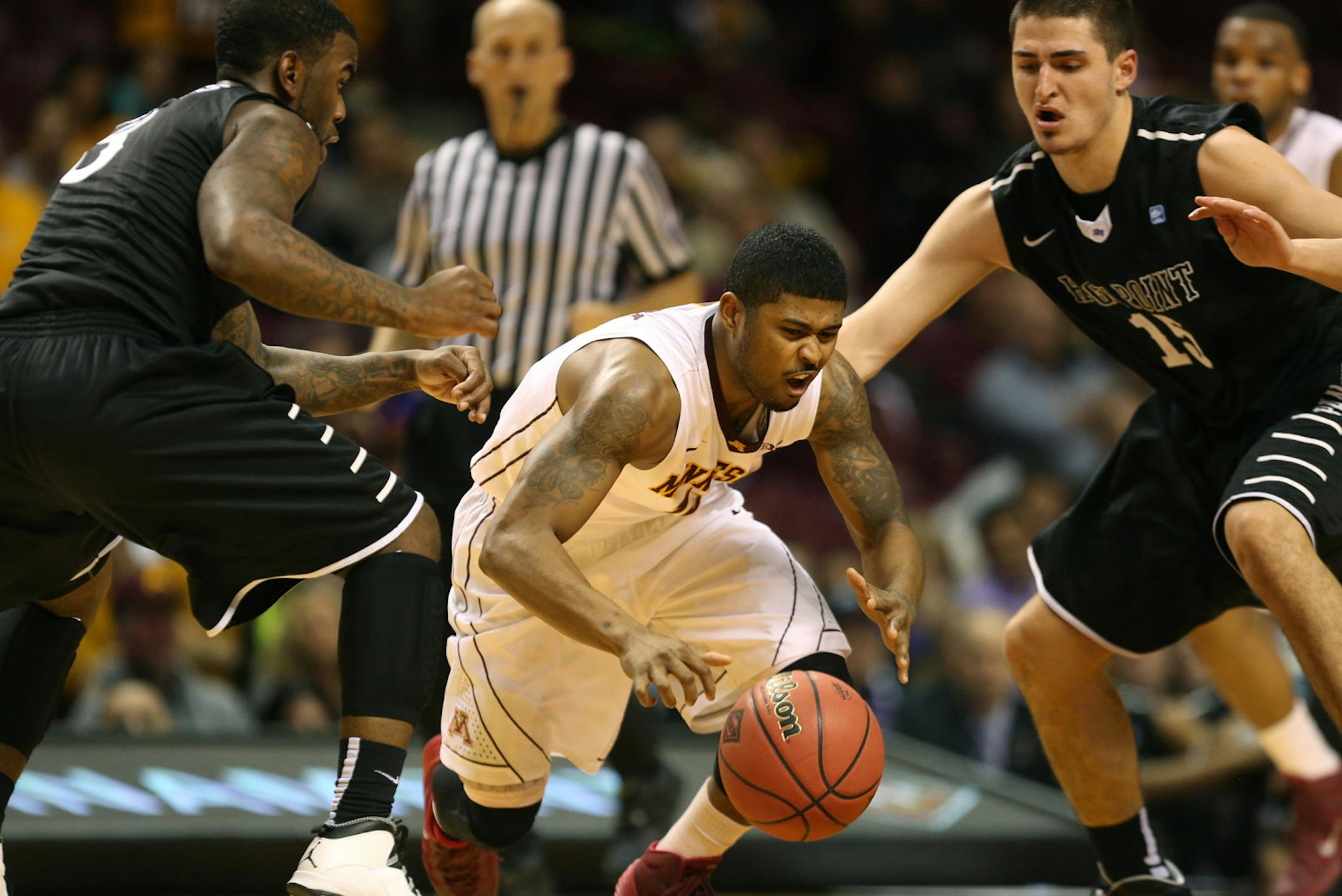 Gopher Maverick Ahanmisi went f to the floor after being fouled by High Point's Lorenzo Cugini in the second half. ] (KYNDELL HARKNESS/STAR TRIBUNE) kyndell.harkness@startribune.com First round of the National Invitational Tournament at Williams Arena in Minneapolis Min, Tuesday March 18, 2014. Gophers won 88-81 over High Point.