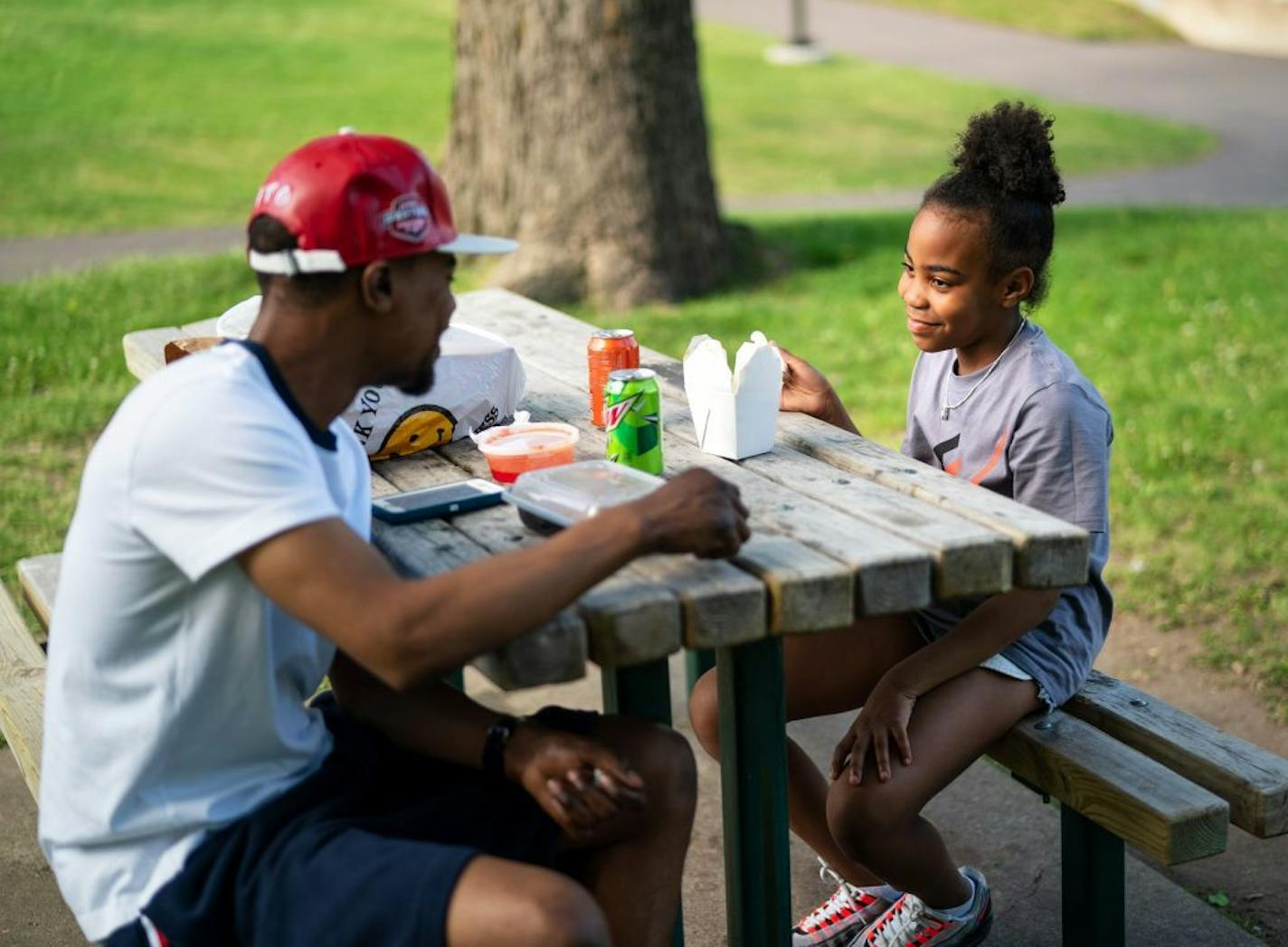 William Lenoir brought his daughter Kaliyah Lenoir Fitzpatrick, 9, to Martin Luther King Park in South Minneapolis for a Chinese food picnic. William has been coming to this park since he was his daughters age and loves it since it was remodeled a few years ago.