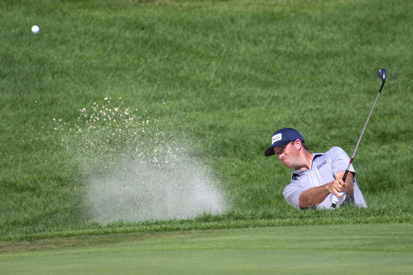 Michael Thompson hits out of a bunker on the 12th hole during the final round of the 3M Open golf tournament in Blaine, Minn., Sunday, July 26, 2020. (AP Photo/Andy Clayton-King)